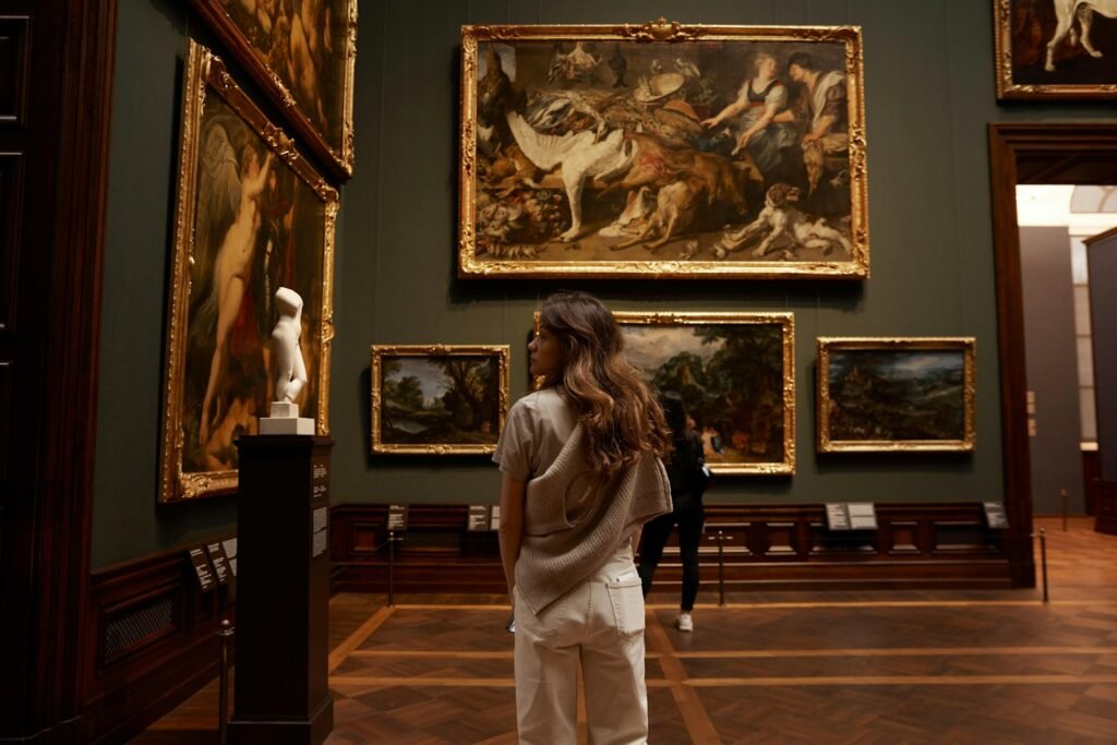 uma mulher olhando pinturas em um museu
